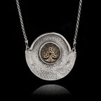 Unique 925 sterling silver statement necklace featuring a round ceramic Tree of Life with Celtic knots, set in a textured hammered silver crescent frame.