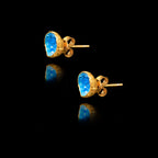 Side view of the gold blue agate studs showing the natural gemstone texture and secure butterfly post fastening.