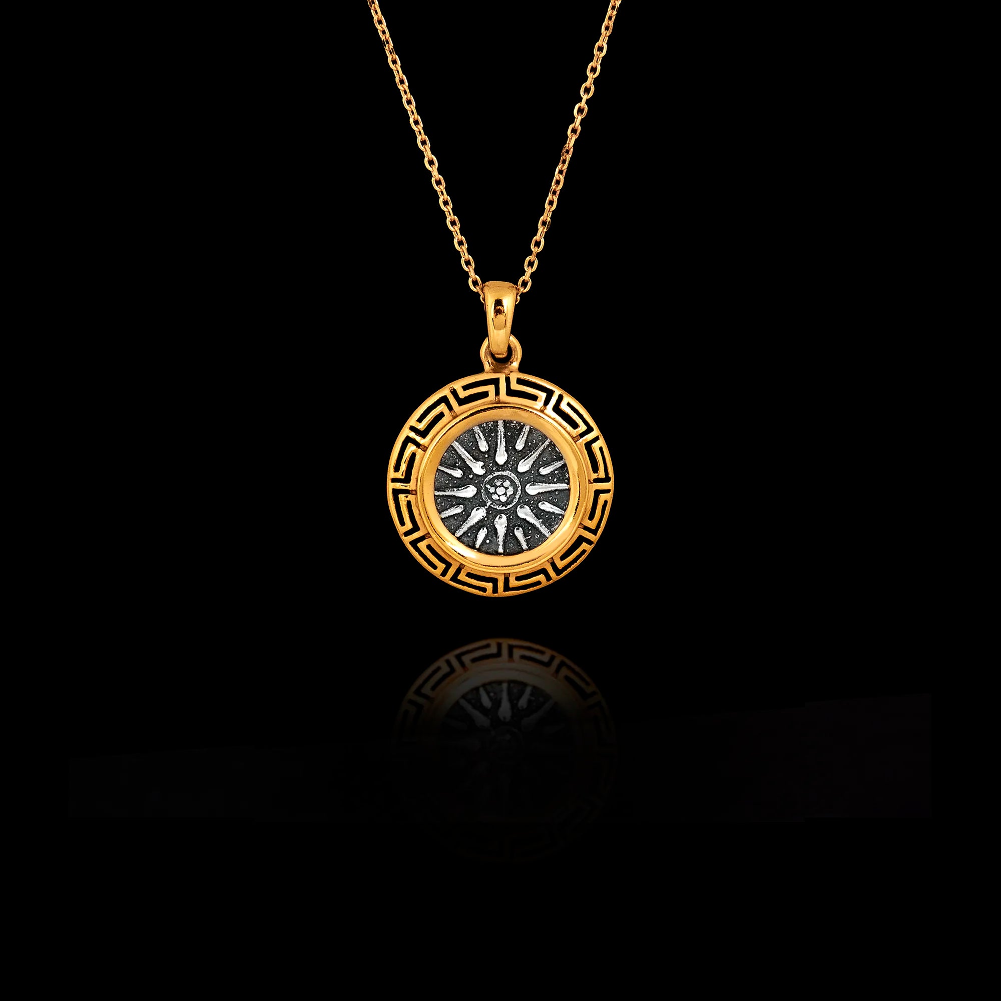 Two-tone 925 sterling silver pendant necklace featuring an oxidized silver Vergina Sun center surrounded by a gold-plated Meander (Greek Key) frame.