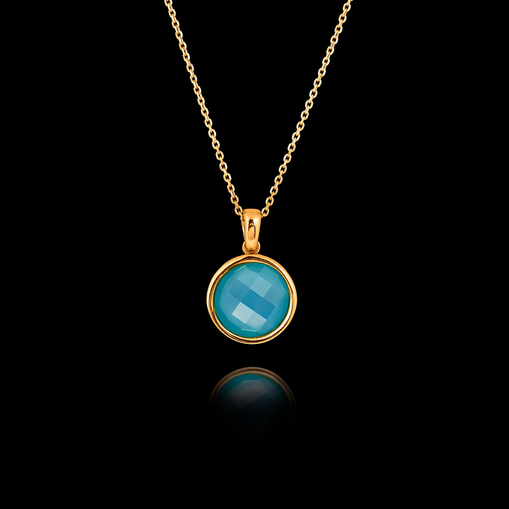 Gold plated 925 sterling silver pendant necklace featuring a round 1cm faceted synthetic turquoise gemstone on an adjustable chain.