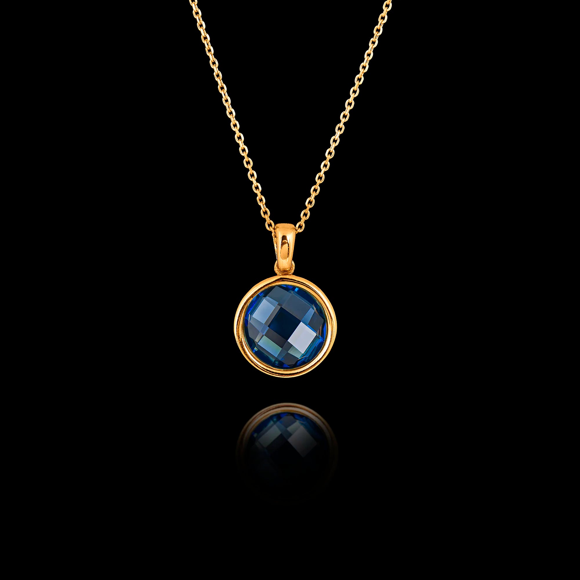 Gold plated 925 sterling silver pendant necklace featuring a round 1cm faceted synthetic blue topaz gemstone on an adjustable chain.