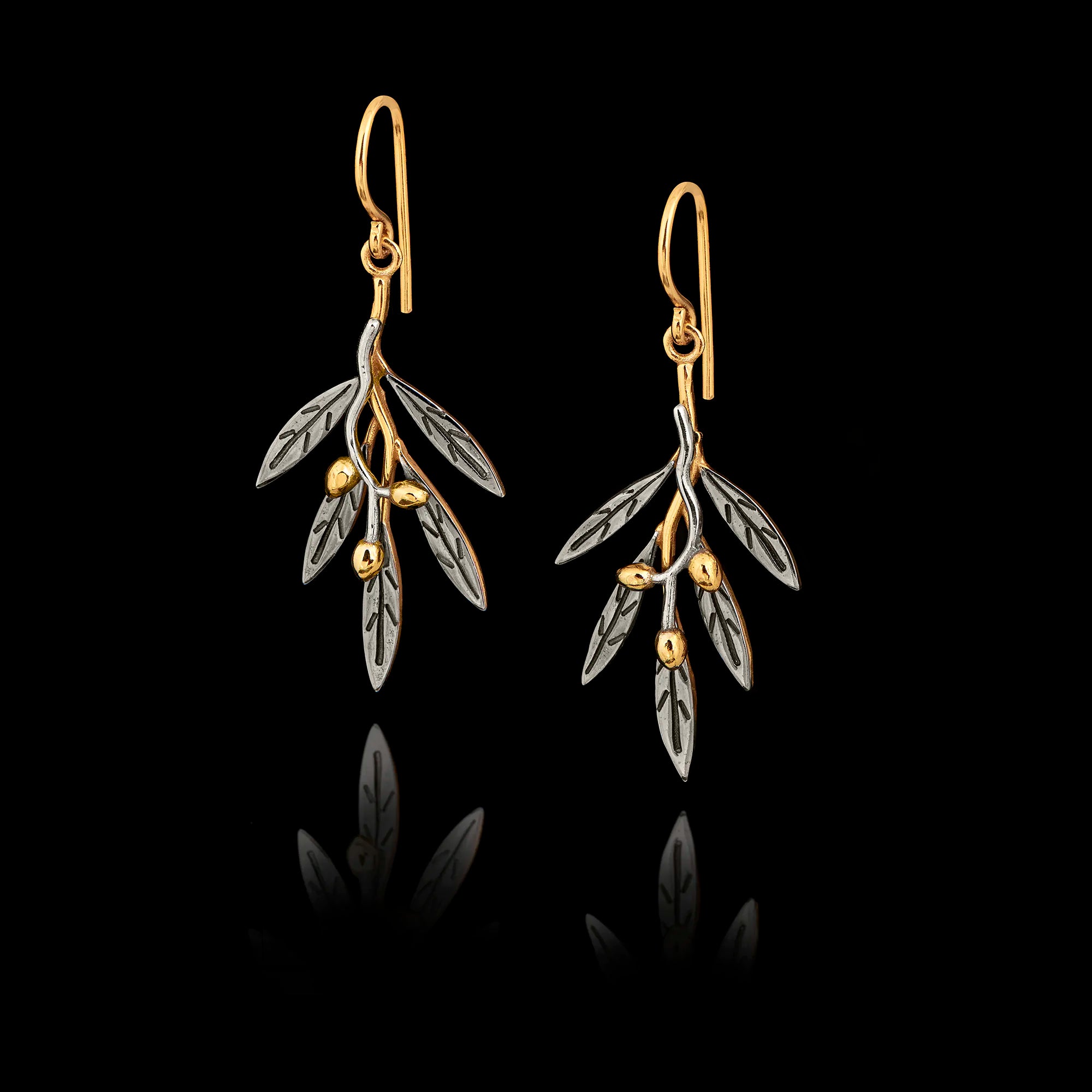 A pair of silver drop earrings shaped like olive branches with rhodium-plated leaves and gold-plated stems and olives. Main image
