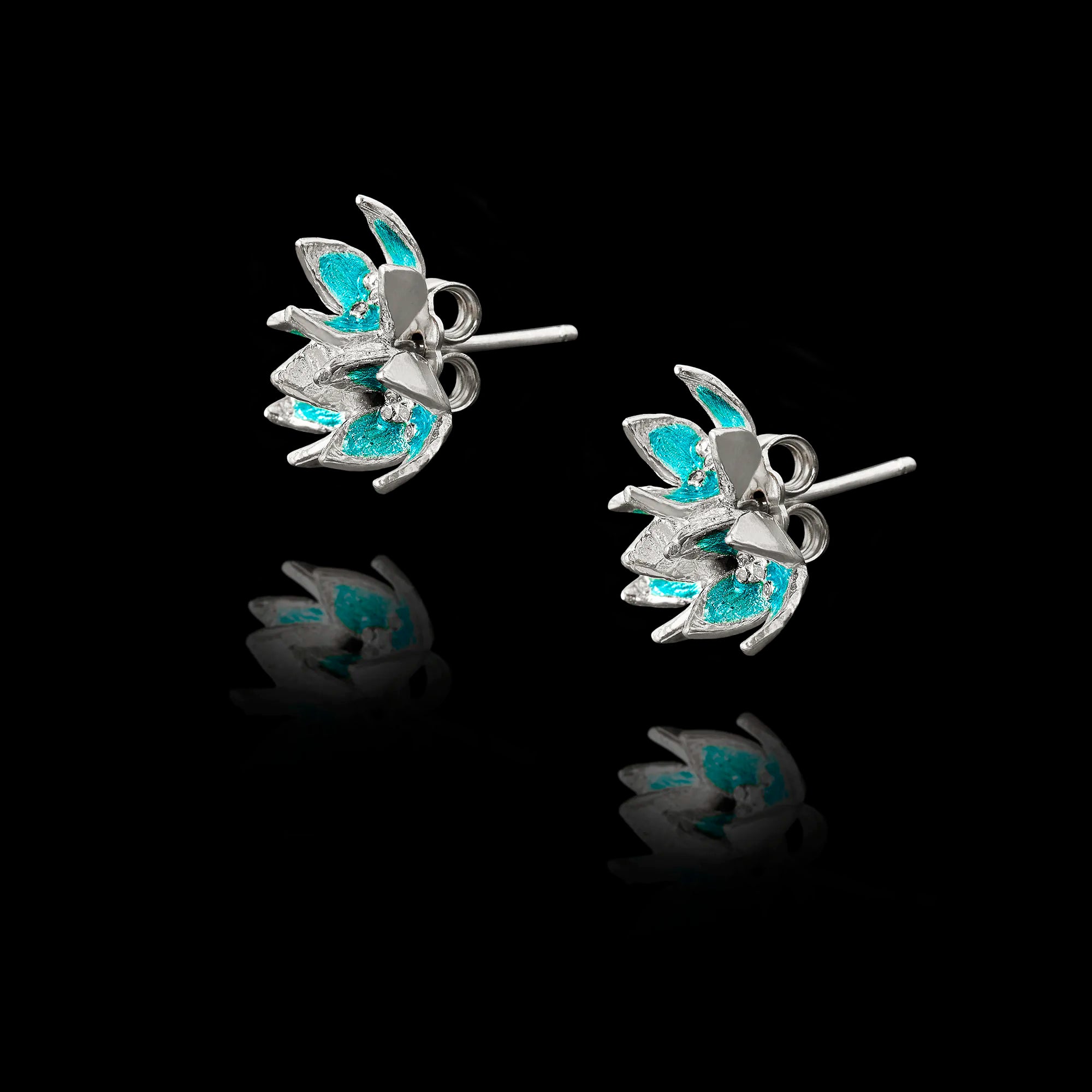 Side view of the flower enamel studs showing the polished silver setting and secure post fastening.
