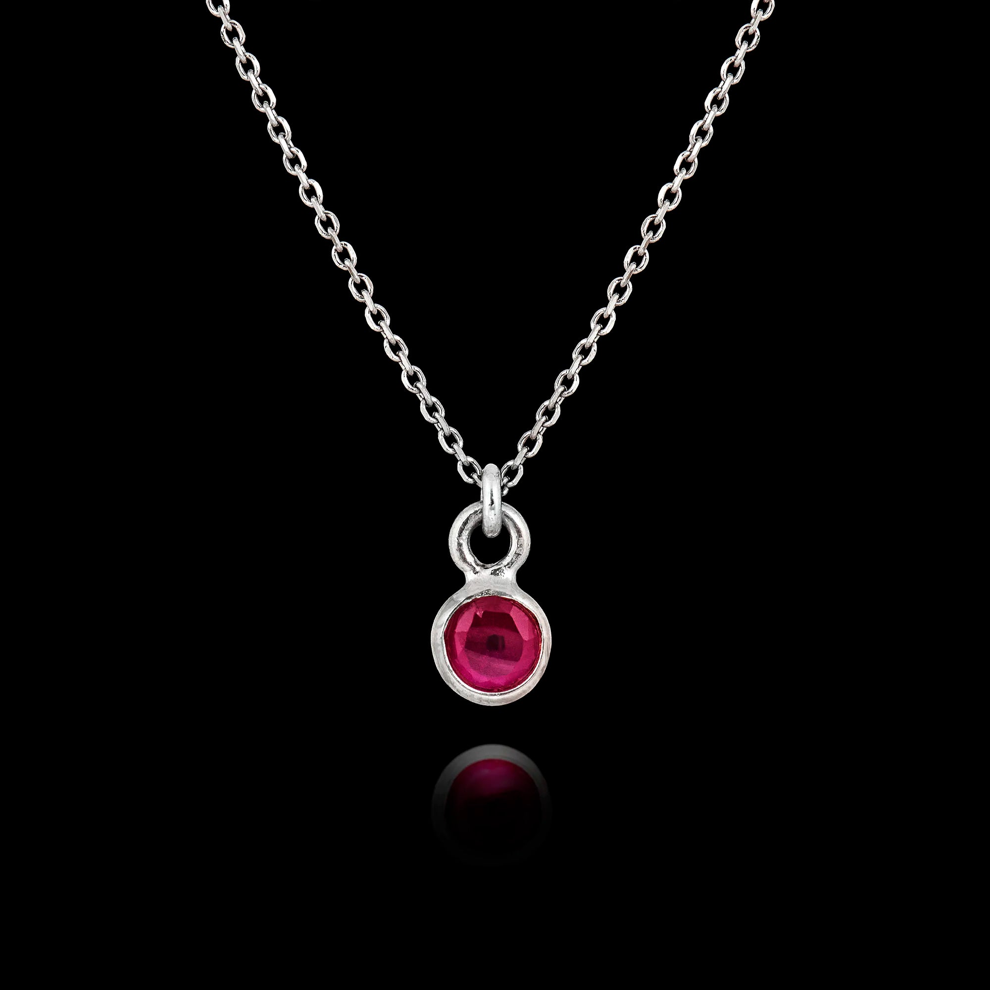 925 sterling silver pendant necklace featuring a round 5mm ruby gemstone in a bezel setting on an adjustable silver chain.