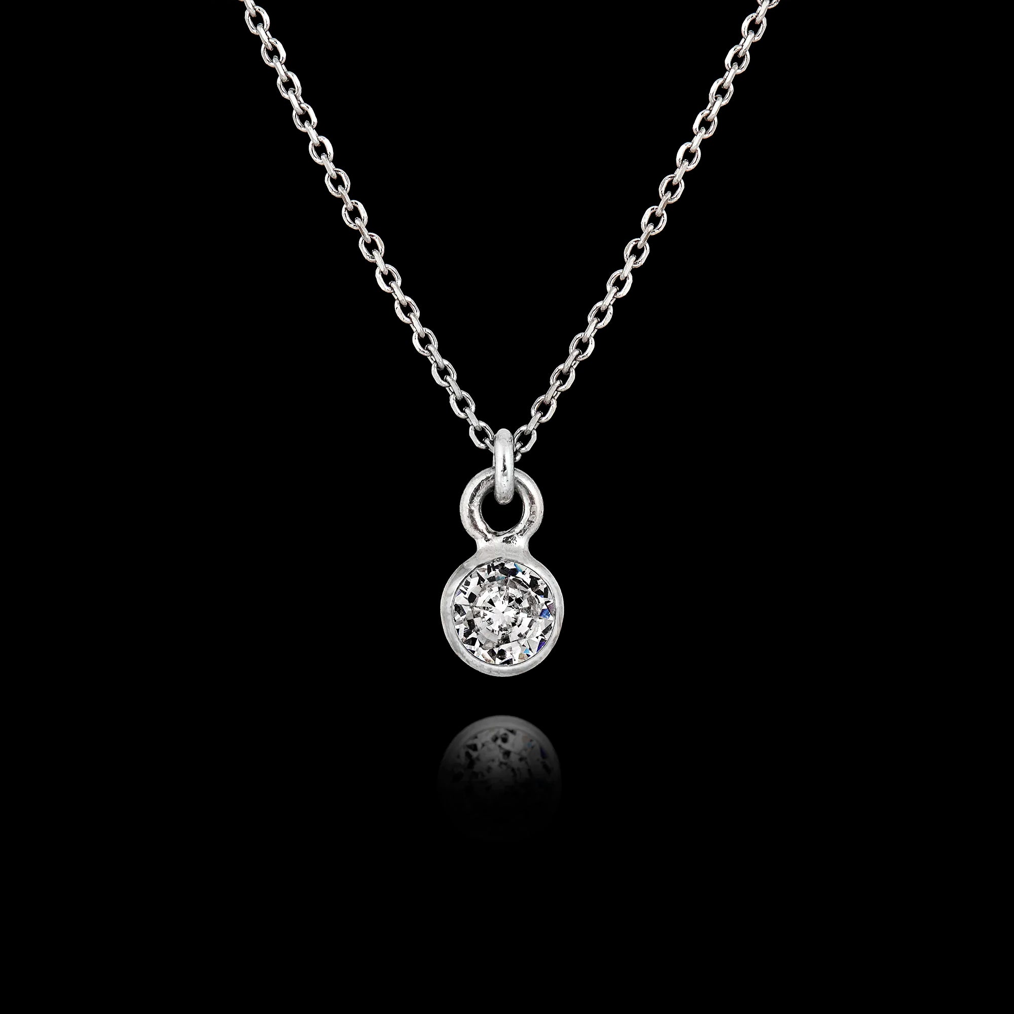 925 sterling silver pendant necklace featuring a round 5mm clear zircon gemstone in a bezel setting on an adjustable silver chain. Main image