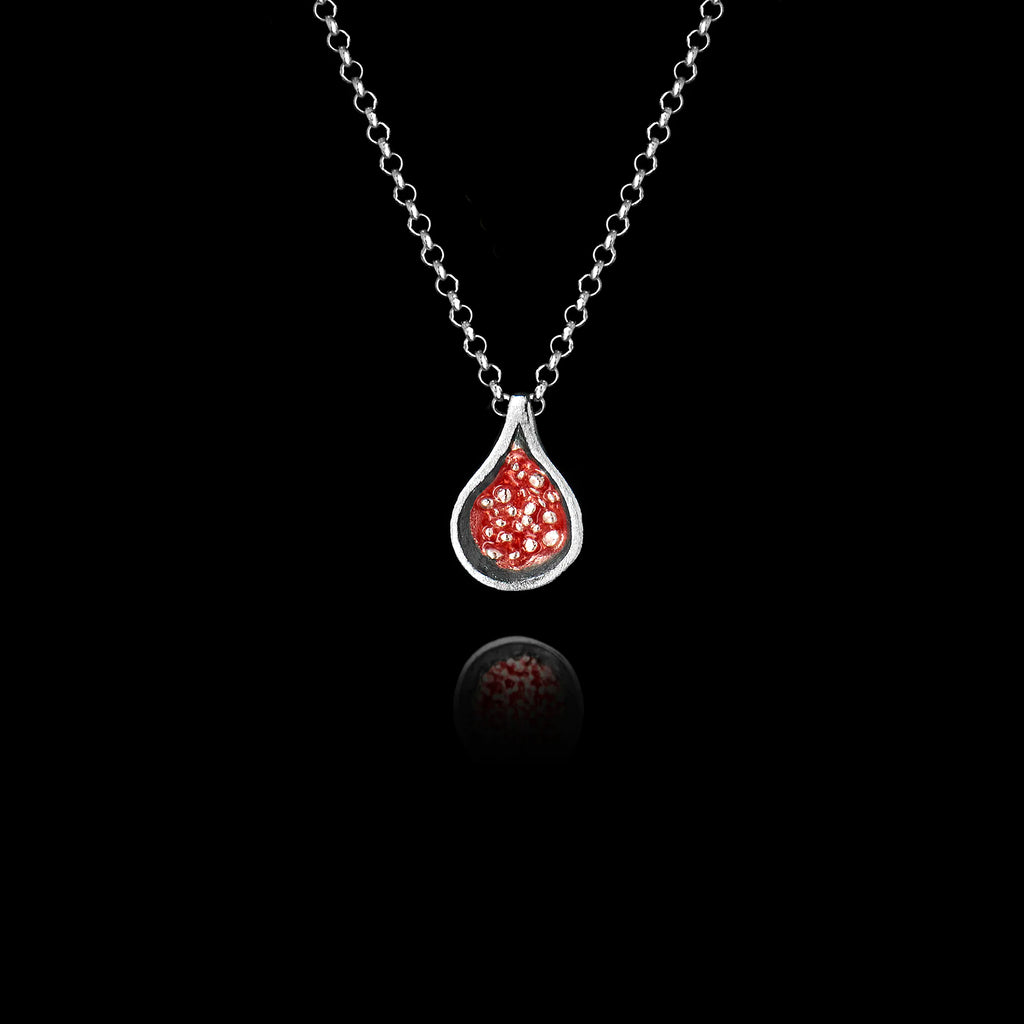 925 sterling silver fig pendant with oxidised silver teardrop frame and vivid red enamel interior with tiny raised silver granule seeds, hanging on a silver chain against a black background.