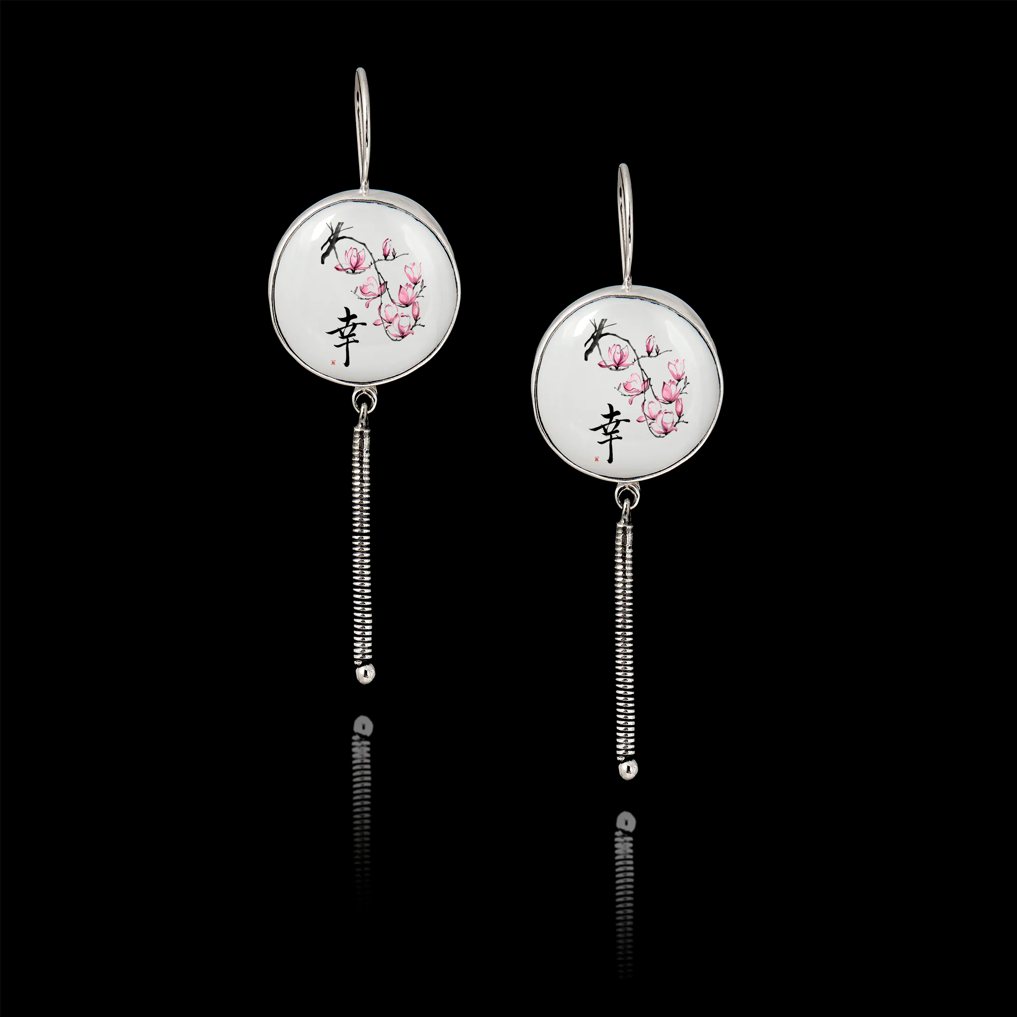 Pair of 925 sterling silver drop earrings featuring a 25mm round ceramic insert with Japanese cherry blossoms and Kanji calligraphy, finished with a long textured silver dangle.