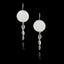 Silver earrings with circular tops and dangling elements on a black background