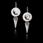 Pair of 925 sterling silver drop earrings featuring 25mm round ceramic inserts with stylized crescent and full moon designs, finished with triangular silver dangles.