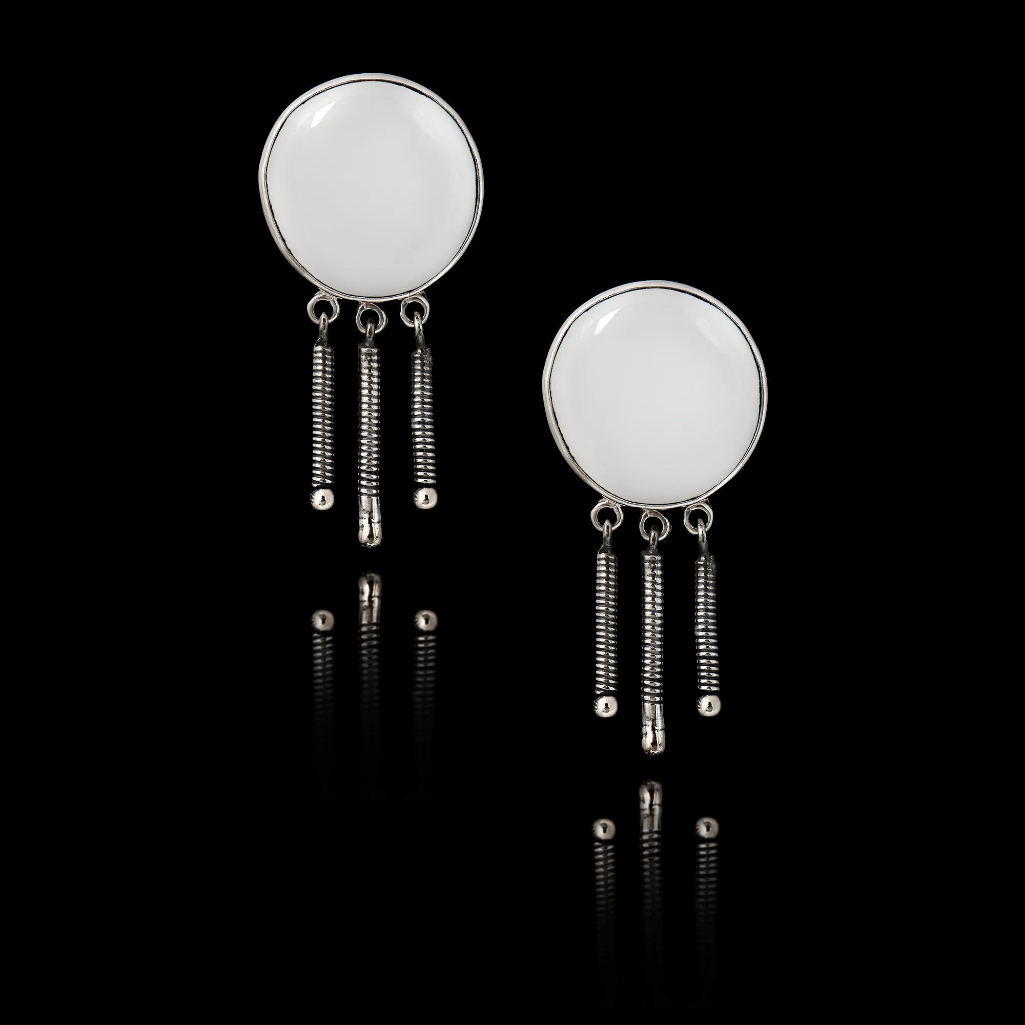 Pair of 925 sterling silver drop earrings featuring a fringe of three textured silver coils and blank white ceramic inserts ready for custom printing.
