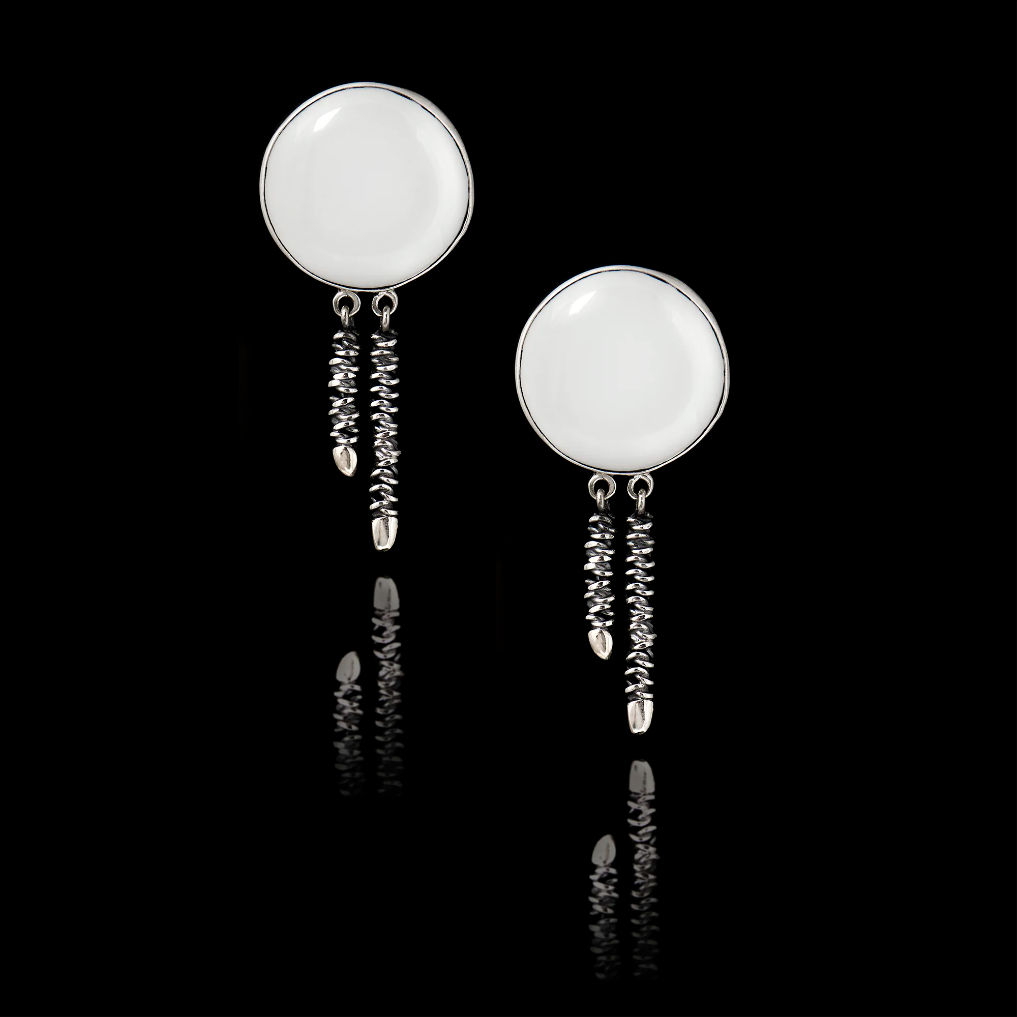 Pair of 925 sterling silver drop earrings featuring twin textured spiral dangles of staggered lengths and blank white ceramic inserts ready for custom printing.