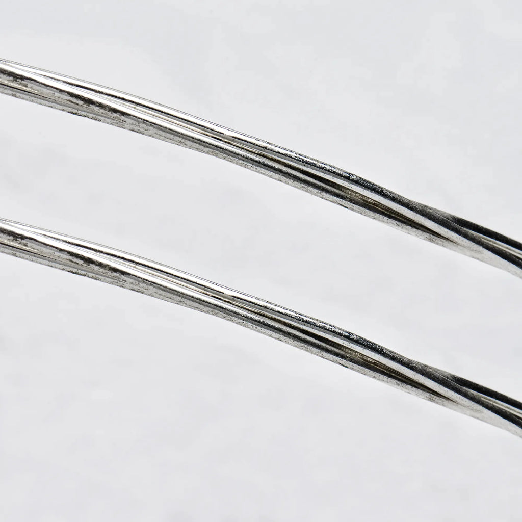 Close-up detail of sterling silver wedding crowns featuring three polished round wires in a minimalist design.