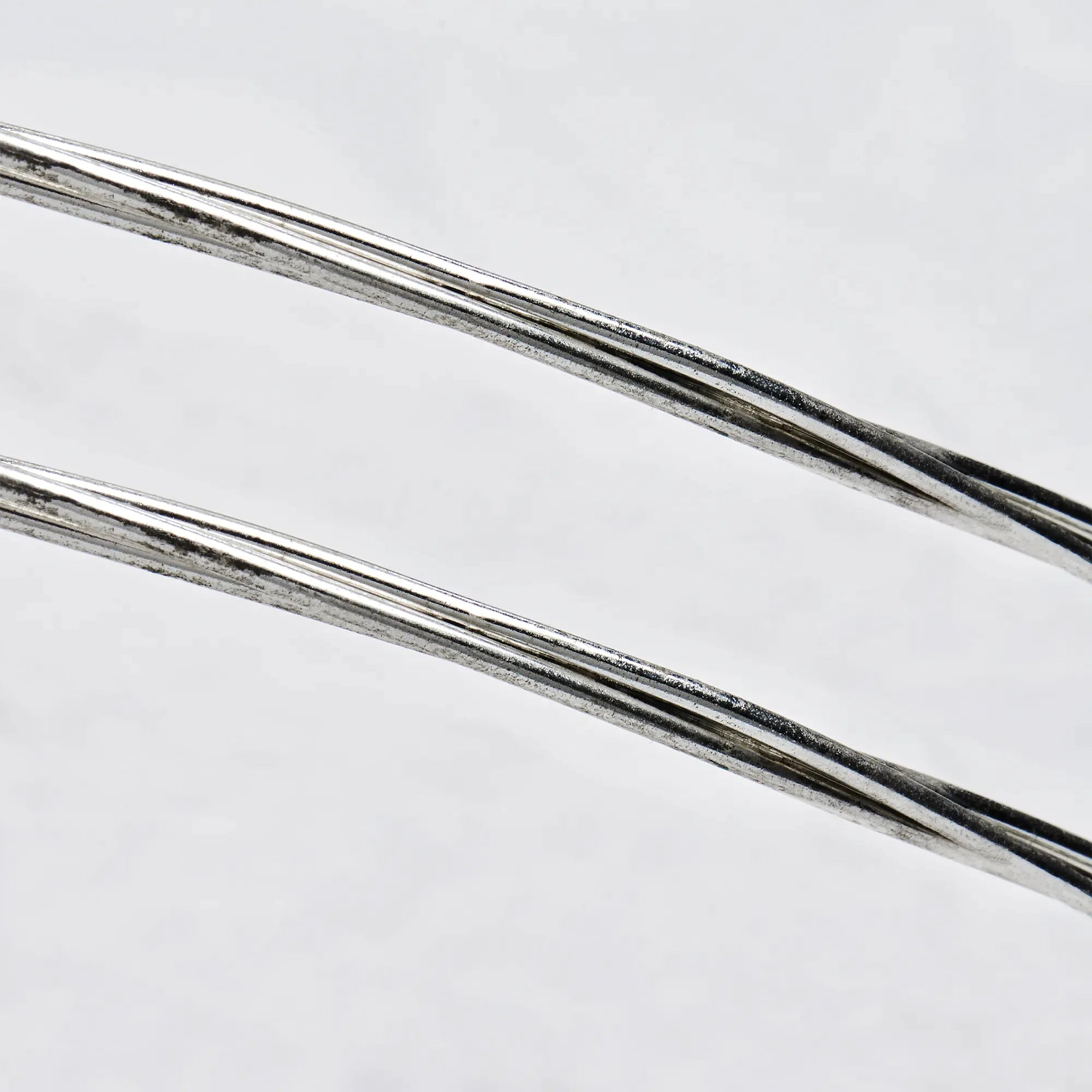 Close-up detail of sterling silver wedding crowns featuring three polished round wires in a minimalist design.