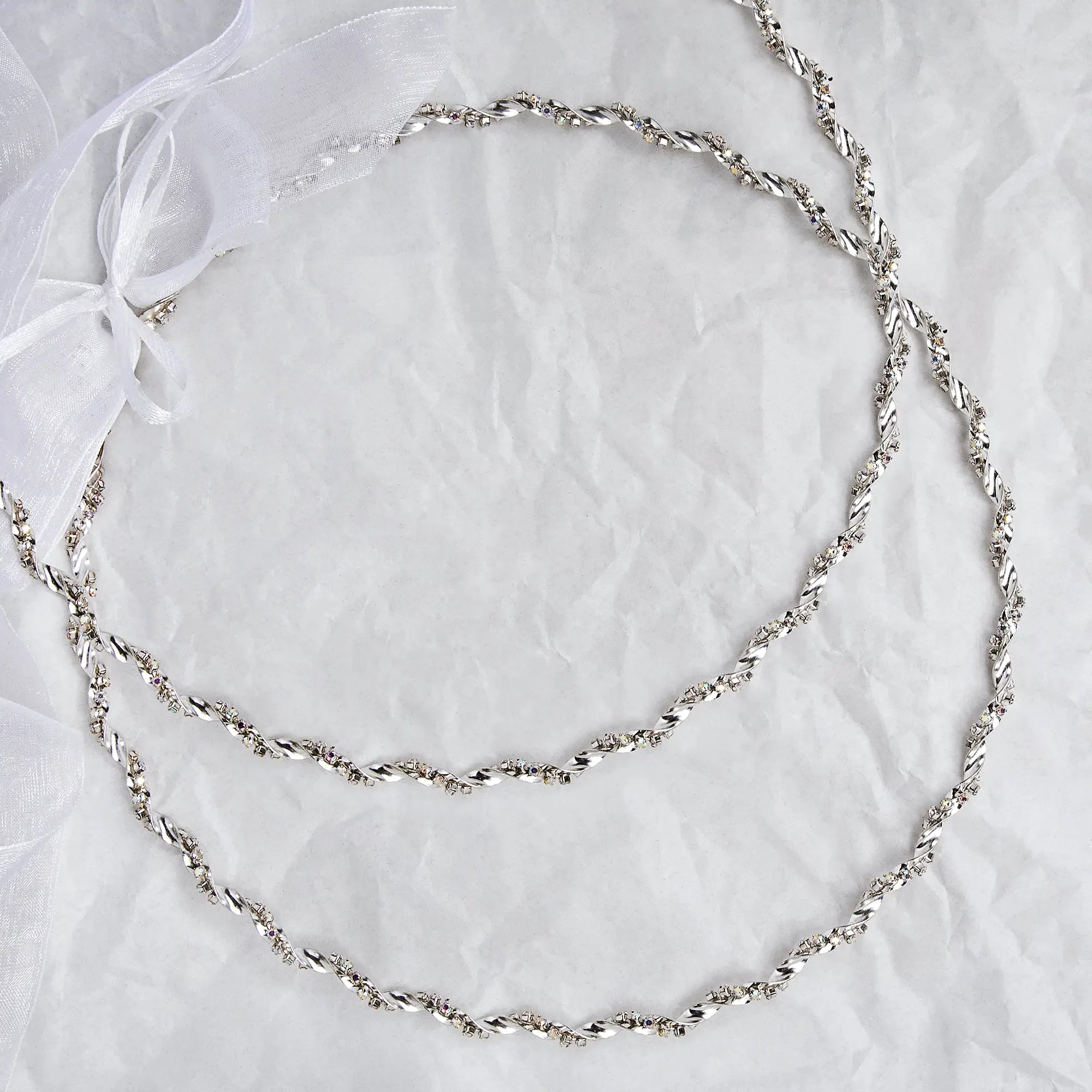 Handmade sterling silver wedding crowns with silver-plated trim and multicolored crystals on a white textured background. Main image