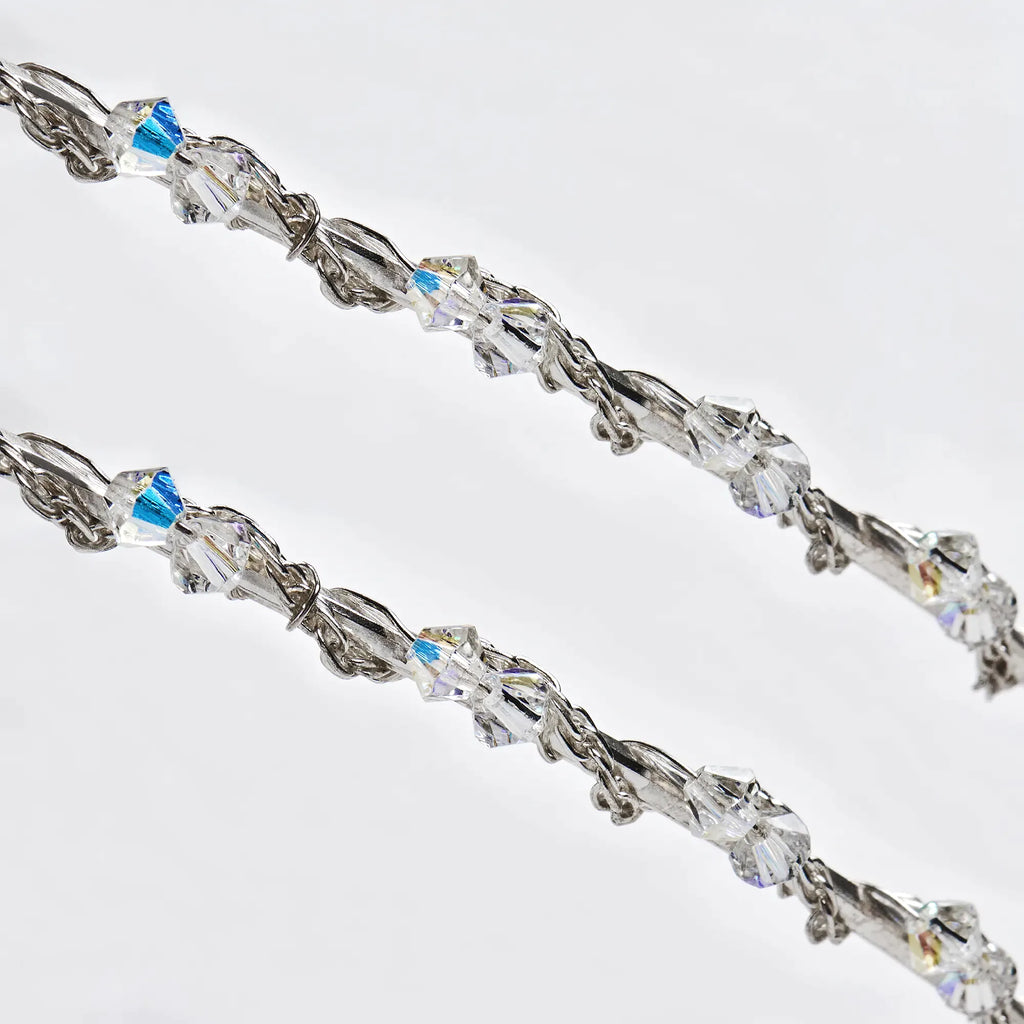 Detailed close-up of sterling silver Stefana featuring a braided Spiga chain and sparkling Swarovski crystals.