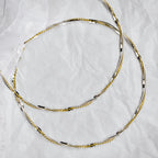 Full view of handmade two-tone wedding crowns in sterling silver and gold plating with a white organza ribbon.