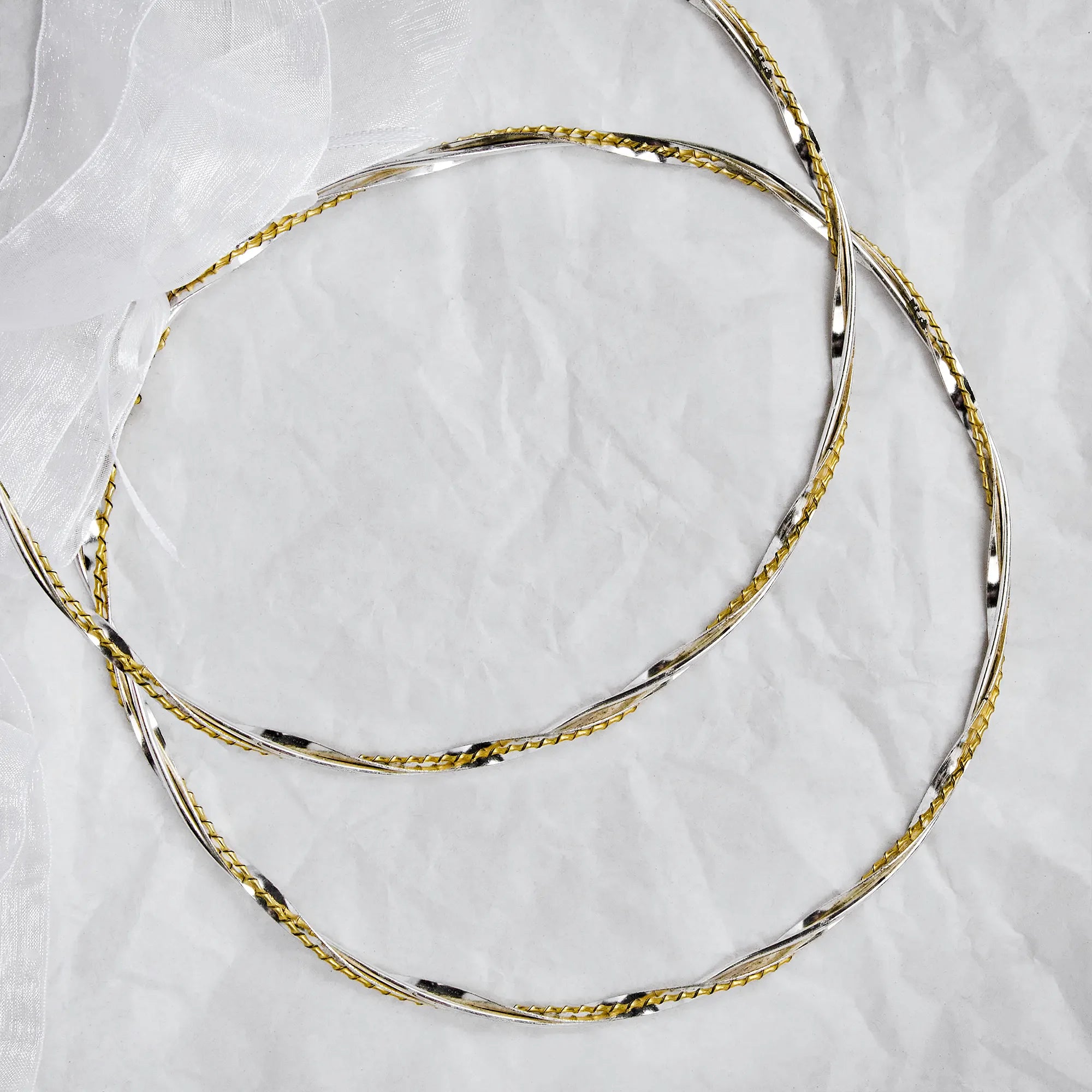 Full view of handmade two-tone wedding crowns in sterling silver and gold plating with a white organza ribbon. Main image