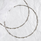 Full view of handmade braided silver wedding crowns featuring thick round wires and intricate twisted details.