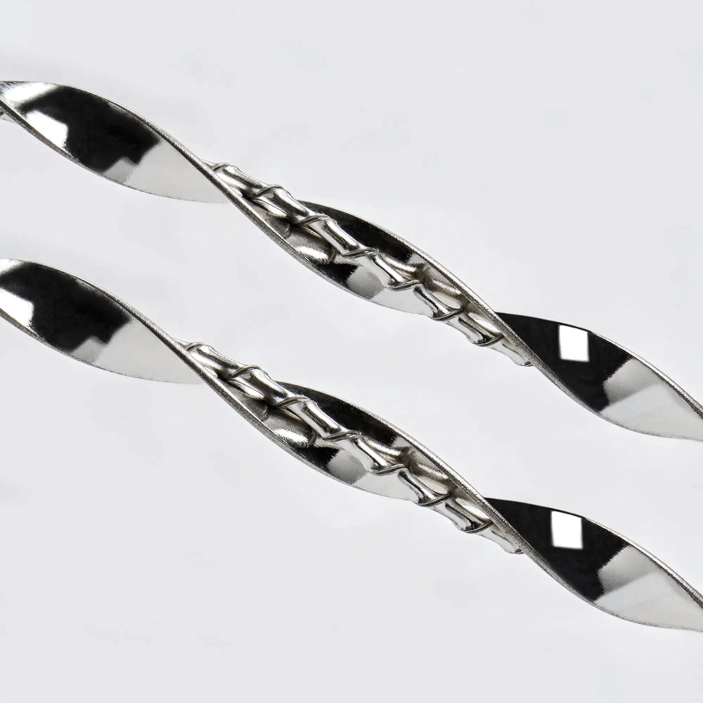 Close-up detail of the intricate dual-twisted sterling silver design, showing the play of light on the silver ribbon.