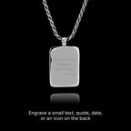 Silver pendant with engraved text on a black background