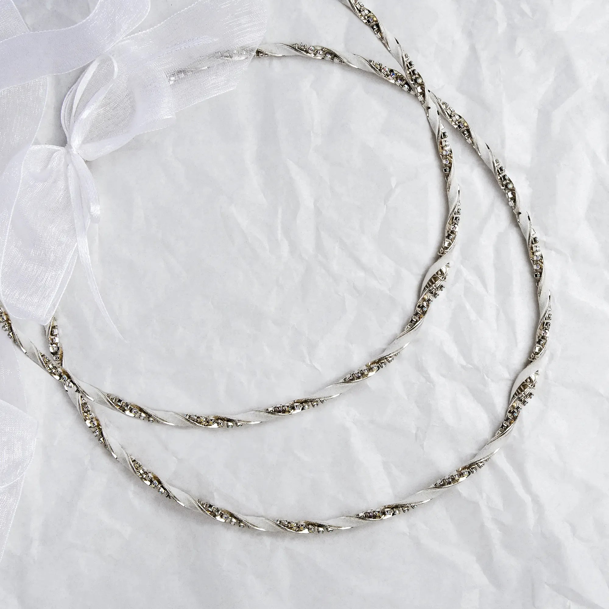 Handmade sterling silver wedding crowns featuring twisted lamina, leather wrap, and multicolored crystals with a white ribbon. Main image